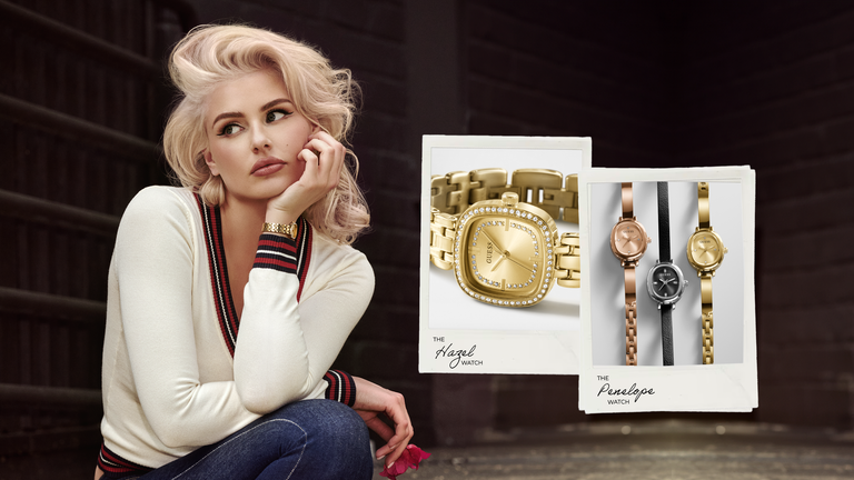 A blonde woman in a cream sweater and jeans poses against a dark wooden background, next to two product display cards showing gold and rose gold women's watches 