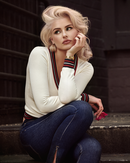 woman in white sweater sitting on steps