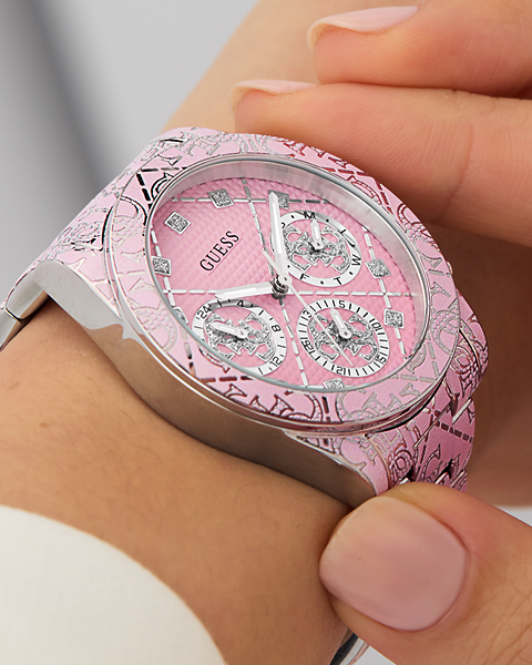 Pink and silver watch on a wrist with a blurred background