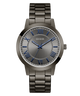Guess watch with metallic band and blue hour markers on a white background