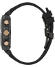 A close-up side view of a rugged smartwatch with a black textured case, three rose gold buttons, and a black silicone strap on a white background.