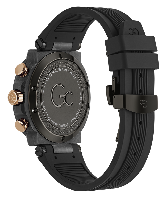 The back view of a Gc One 20th Anniversary Limited Edition Chronograph watch with a black textured silicone strap, a dark gray carbon fiber case, and rose gold accents on the side buttons and crown.