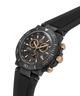 A carbon fiber chronograph watch with a black dial, black bezel, and a black rubber strap, accented with rose gold-tone hands, markers, and pushers. lifestyle