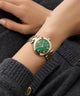 Gc Illusion Small Size Metal Green watch with gold accents on a wrist against a dark background
