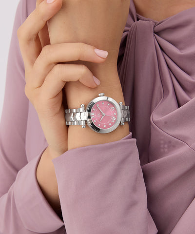 Gc Illusion Small Size Metal watch with pink face on a wrist, wearing a mauve top.