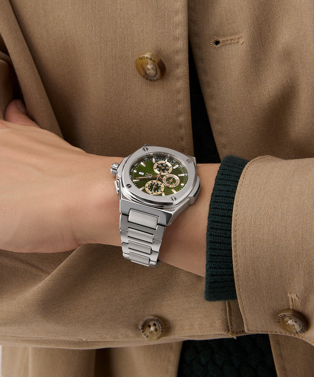 Gc Coussin Shape Chrono Metal Silver watch on a wrist with a beige coat background