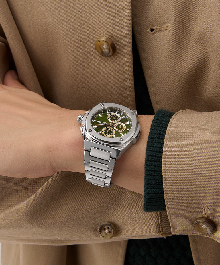 Gc Coussin Shape Chrono Metal Silver watch on a wrist with a beige coat background