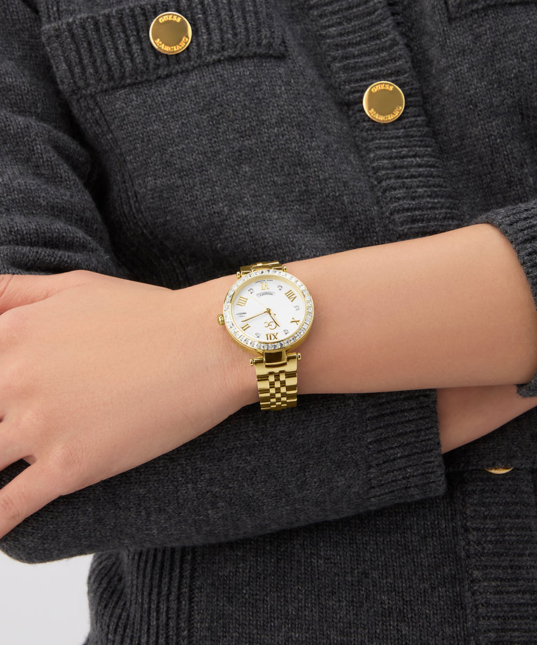 Gc Flair Crystal Mid Size Metal Gold watch on a wrist with a dark gray textured background