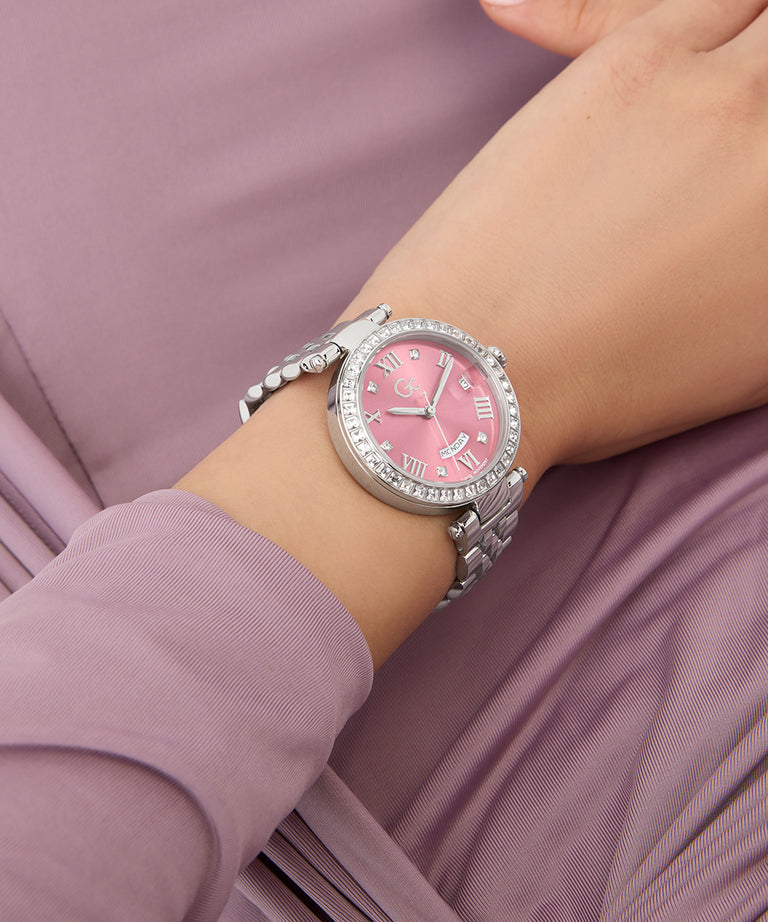 Z12010L9 Pink watch with silver bracelet on a wrist against a pink background