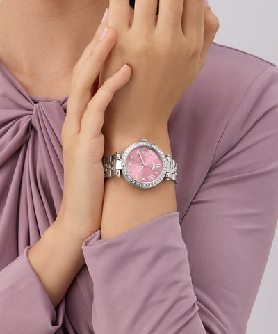 Z12010L9 Pink watch with silver bracelet on a wrist, against a light pink background