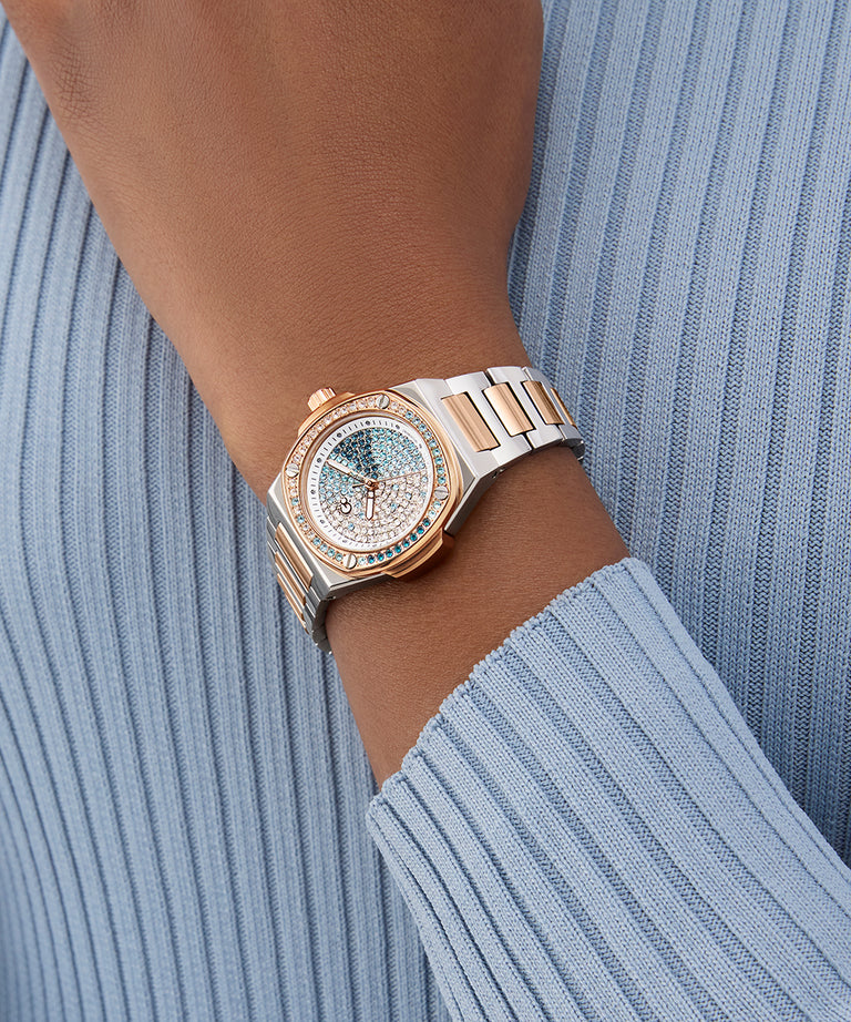 Gc Coussin Shape Mini Small Size Metal watch on a wrist with a light blue ribbed sweater