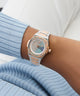 Gc Coussin Shape Mini Small Size Metal watch with a detailed face on a wrist, wearing a light blue ribbed sweater.