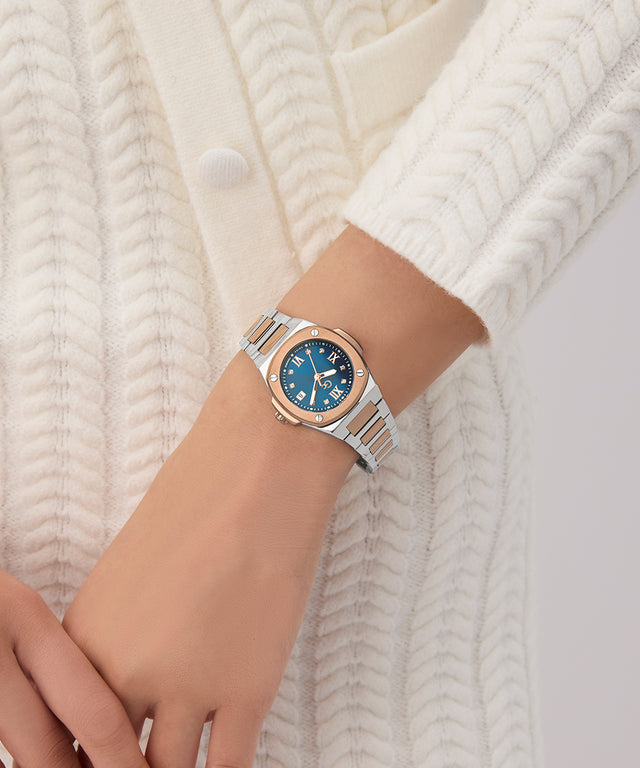 Gc Coussin Shape Mini Small Size Metal Silver watch with a blue face on a wrist against a white background