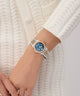 Gc Coussin Shape Mini Small Size Metal Silver watch with a blue face on a wrist against a white background