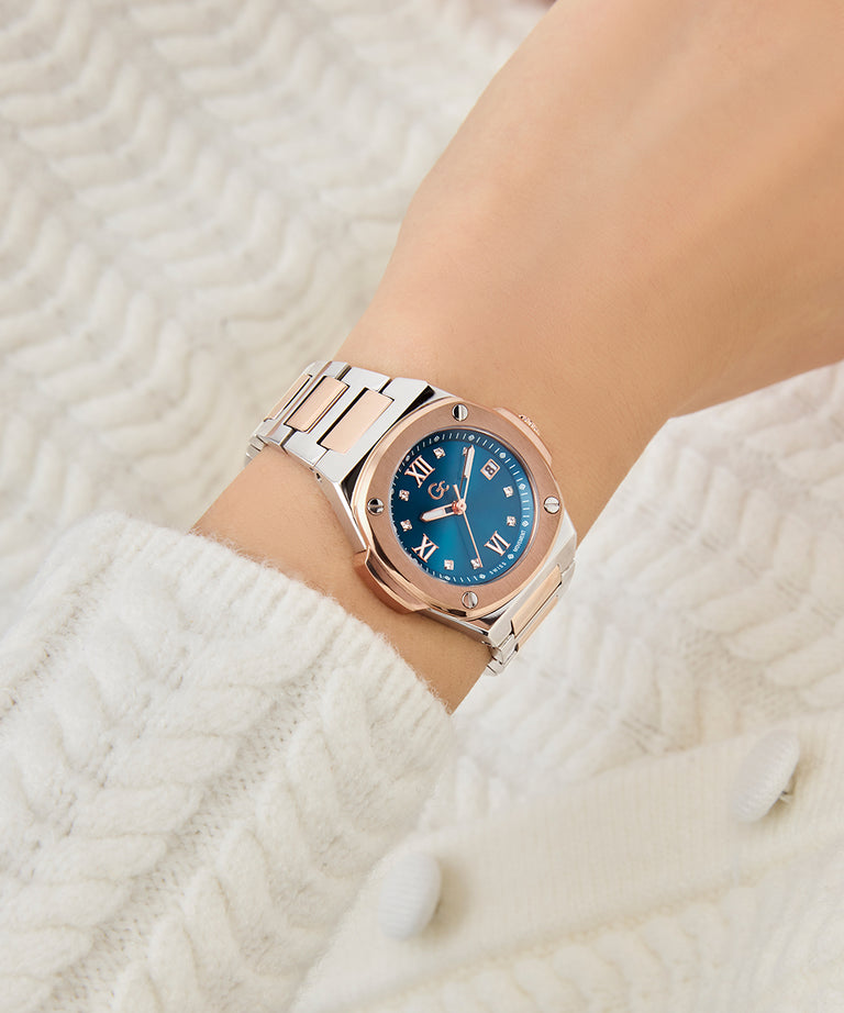 Gc Coussin Shape Mini Small Size Metal Rose gold watch with blue dial on a wrist against a white textured background