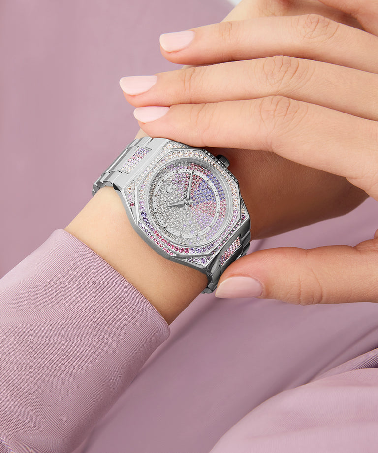 Gc Coussin Sleek Lady Mid Size Metal watch with diamond accents on a wrist against a pink background