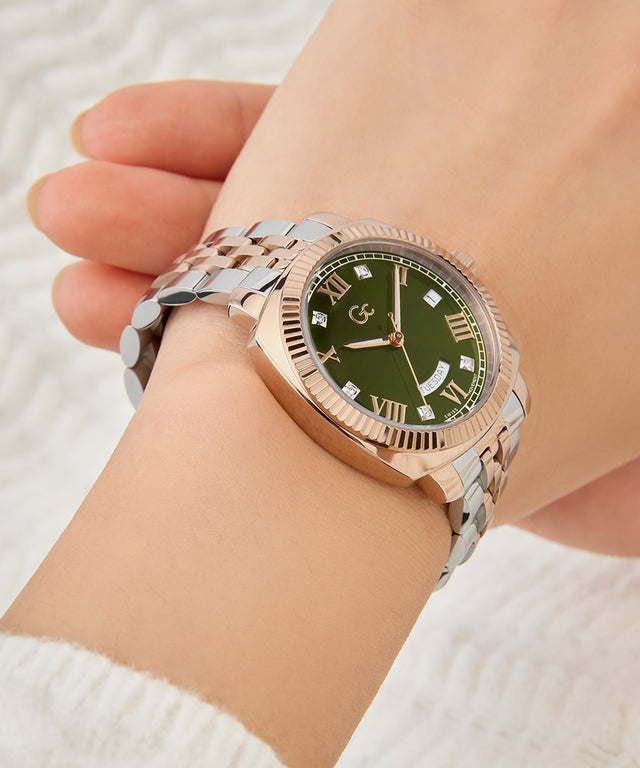 Gc Flair Coussin Lady Mid Size Metal Rose gold watch with a green dial on a wrist against a white background