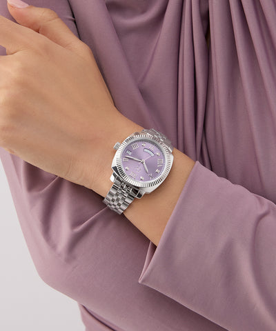 Silver Gc Flair Coussin Lady Mid Size Metal watch with a purple face on a wrist, wearing a matching outfit.