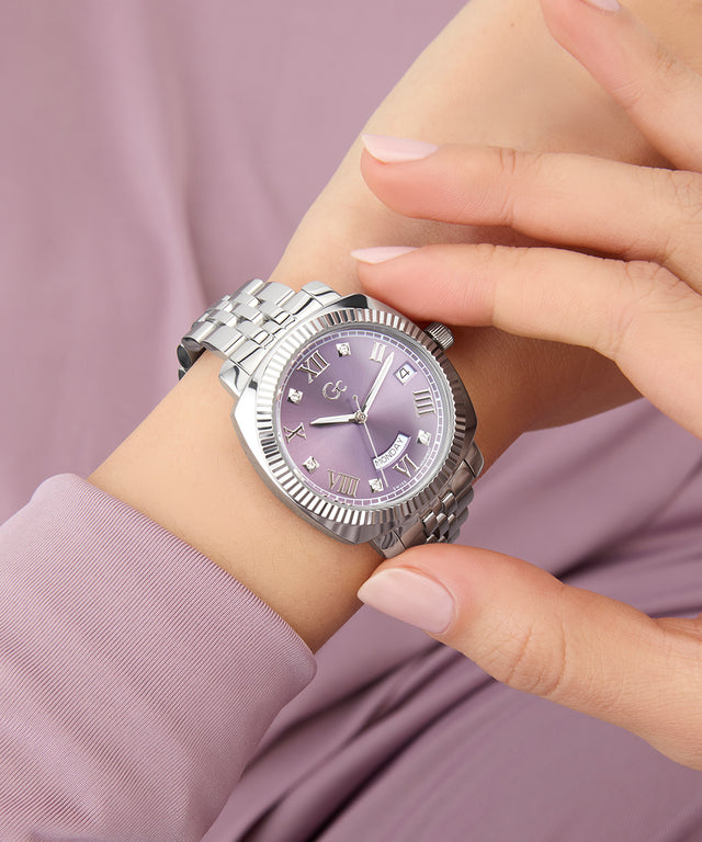 Silver Gc Flair Coussin Lady Mid Size Metal watch with a purple face on a wrist against a pink background