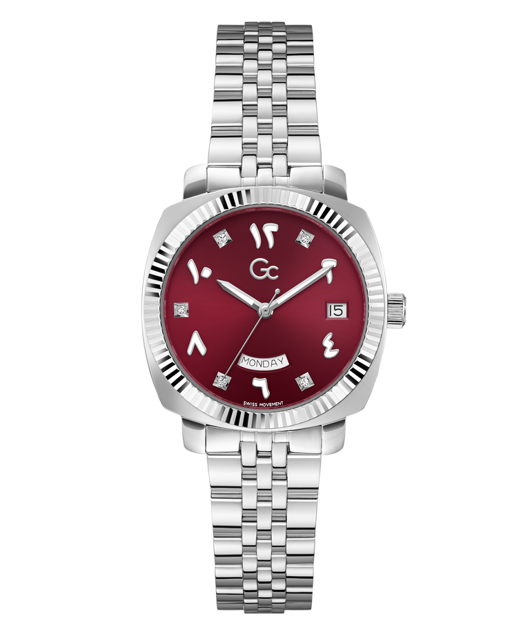 A wristwatch with a silver stainless steel link bracelet, a silver-tone case, and a deep red dial featuring Arabic numerals and a day/date window.