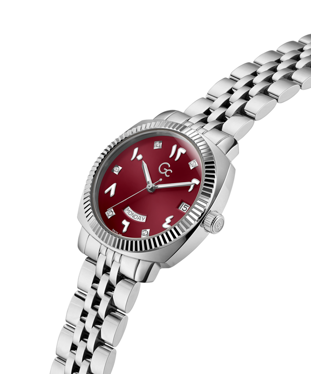 A women's stainless steel watch with a silver-tone link bracelet, featuring a round red dial with silver-tone Arabic numerals and a fluted bezel, shown on a plain white background. lifestyle