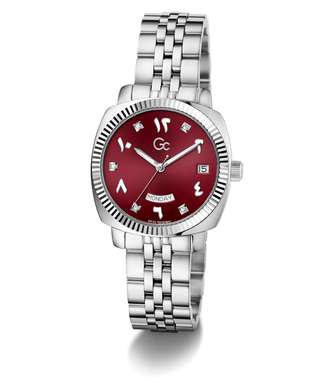 A Gc women's watch featuring a silver-tone stainless steel link bracelet, a fluted bezel, and a deep red dial with silver Arabic numerals and diamond hour markers.