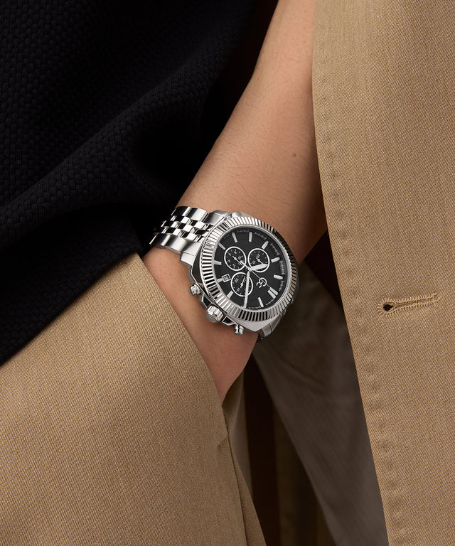 Gc Flair Coussin Chrono Metal Silver watch on a wrist with a person wearing a beige coat