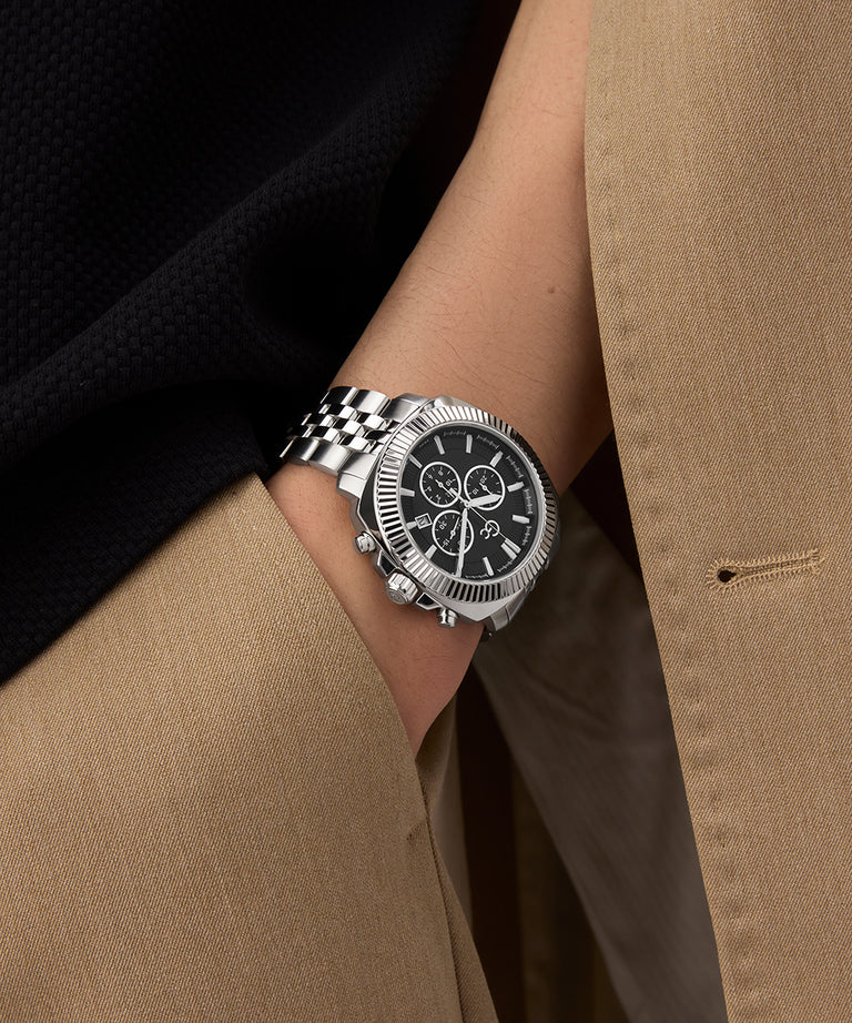 Gc Flair Coussin Chrono Metal Silver watch on a wrist with a person wearing a beige coat