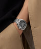 Gc Flair Coussin Chrono Metal Silver watch on a wrist with a person wearing a beige coat