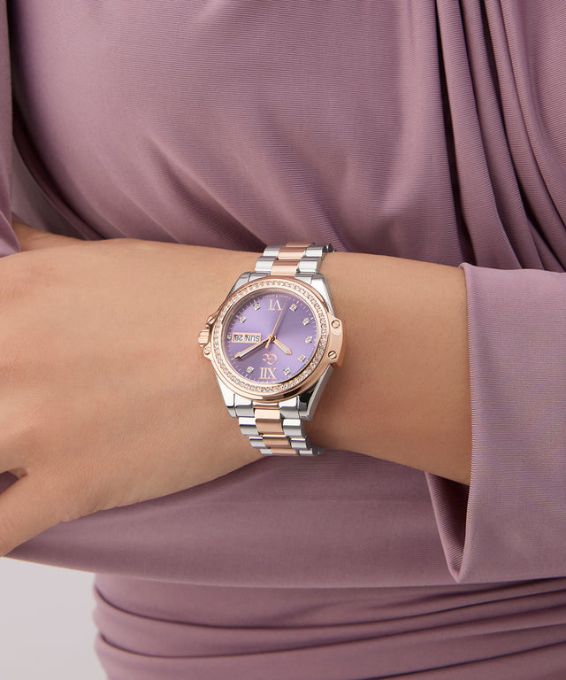 Gc Bolt Lady Mid Size Metal Silver watch with a purple face on a wrist against a matching purple garment.