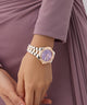 Gc Bolt Lady Mid Size Metal Gold watch on a wrist with a blurred purple background