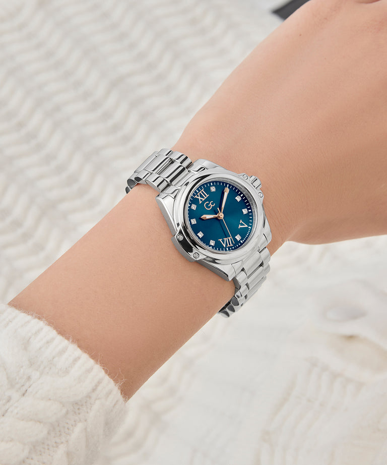 Gc Bolt Lady Mini Small Size Metal Silver watch with a blue dial on a wrist against a neutral background