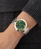 Gc TopChic Large Size Metal Green watch with gold accents on a wrist against a dark background