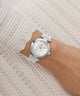 Gc TopChic Mid Size Metal watch on a wrist with a white lace background