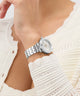 Gc TopChic Mid Size Metal watch on a wrist with a white textured garment