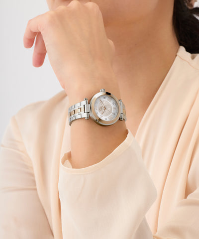 Silver Gc TopChic Mid Size Metal watch on a person's wrist with a light background