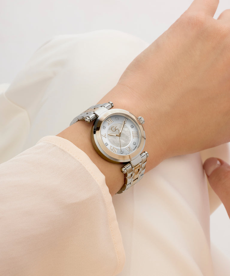 Silver Gc TopChic Mid Size Metal watch on a wrist with a light background