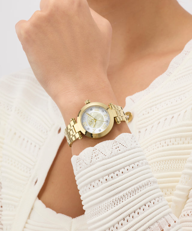 Gold Gc TopChic Mid Size Metal watch on a wrist with a white textured garment