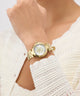 Gold Gc TopChic Mid Size Metal watch on a wrist with a white textured garment