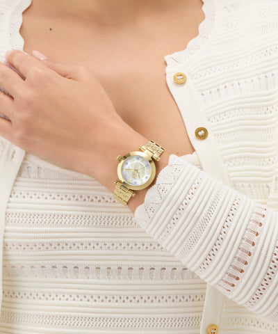 Gold Gc TopChic Mid Size Metal watch on a person's wrist with a white textured sweater