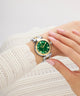 Gc TopChic Mid Size Metal Wristwatch with green face and gold accents on a wrist wearing a white textured sleeve.