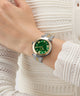 Green Gc TopChic Mid Size Metal watch with gold accents on a wrist against a white textured background