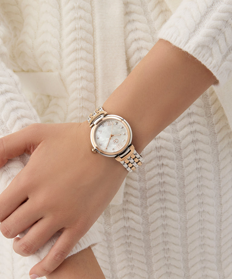 Gc Allure Mid Size Metal Rose gold watch on a wrist against a white textured background