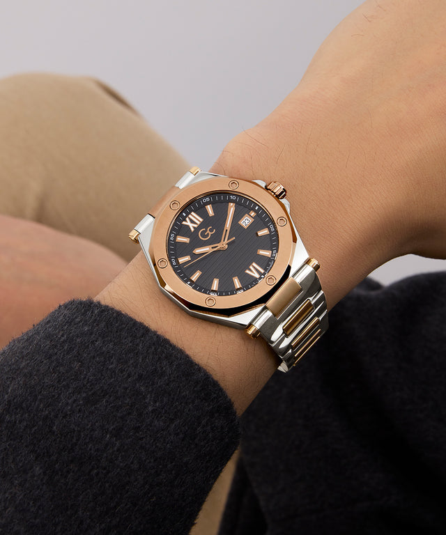 Gc Legacy Sleek Metal Rose gold watch on a wrist with a neutral background