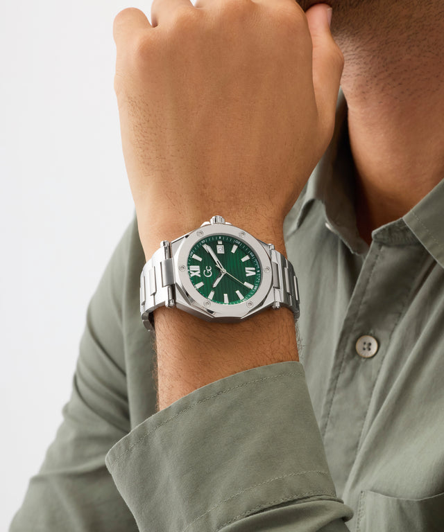 Person wearing a silver Gc Legacy Sleek Metal with a green face on a light gray background