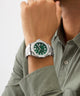 Person wearing a silver Gc Legacy Sleek Metal with a green face on a light gray background