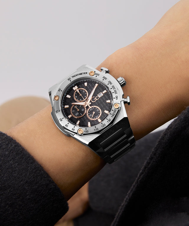 Gc IdolSport Chrono Metal watch with black strap and silver case on a wrist against a neutral background