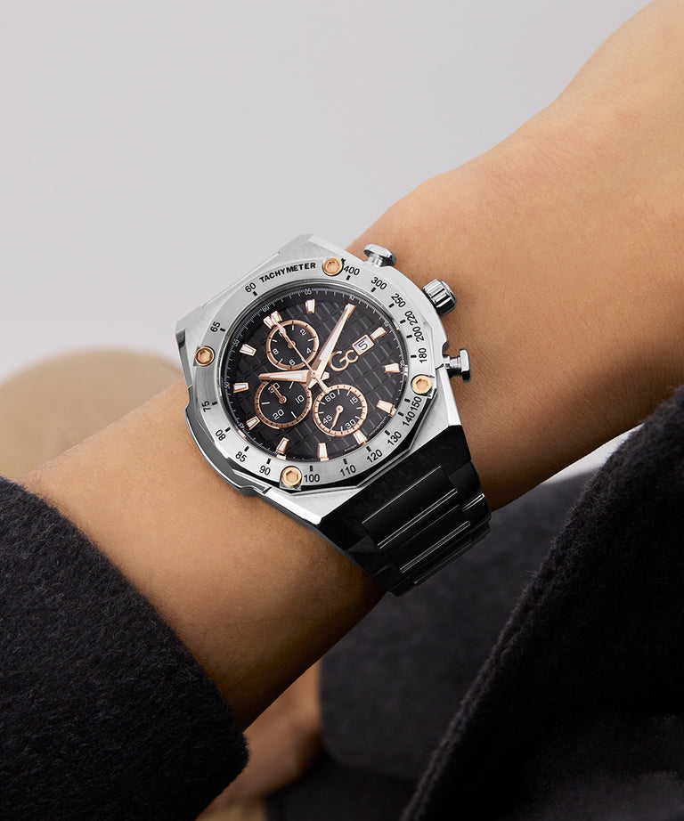 Gc IdolSport Chrono Metal watch with black strap and silver case on a wrist against a neutral background