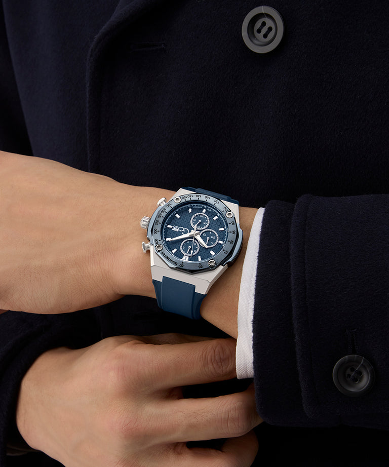 Person wearing a blue Gc IdolSport Chrono Silicone watch on a dark coat background