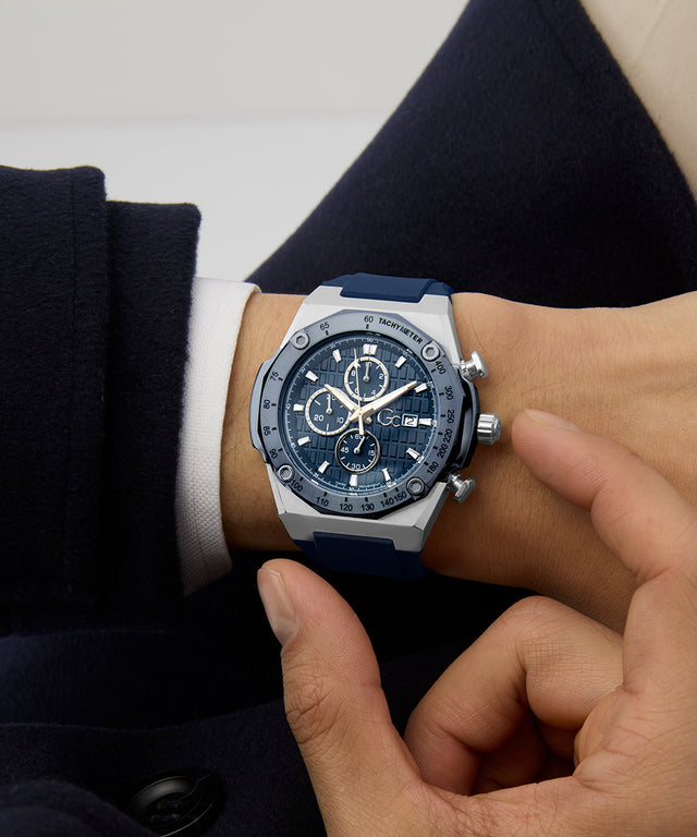 Person wearing a blue and silver Gc IdolSport Chrono Silicone watch on a white background